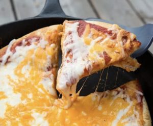Cheese pizza in a cast-iron skillet